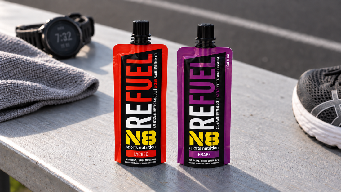 N8 Refuel Lychee and Grape caffeine energy gels beside running gear