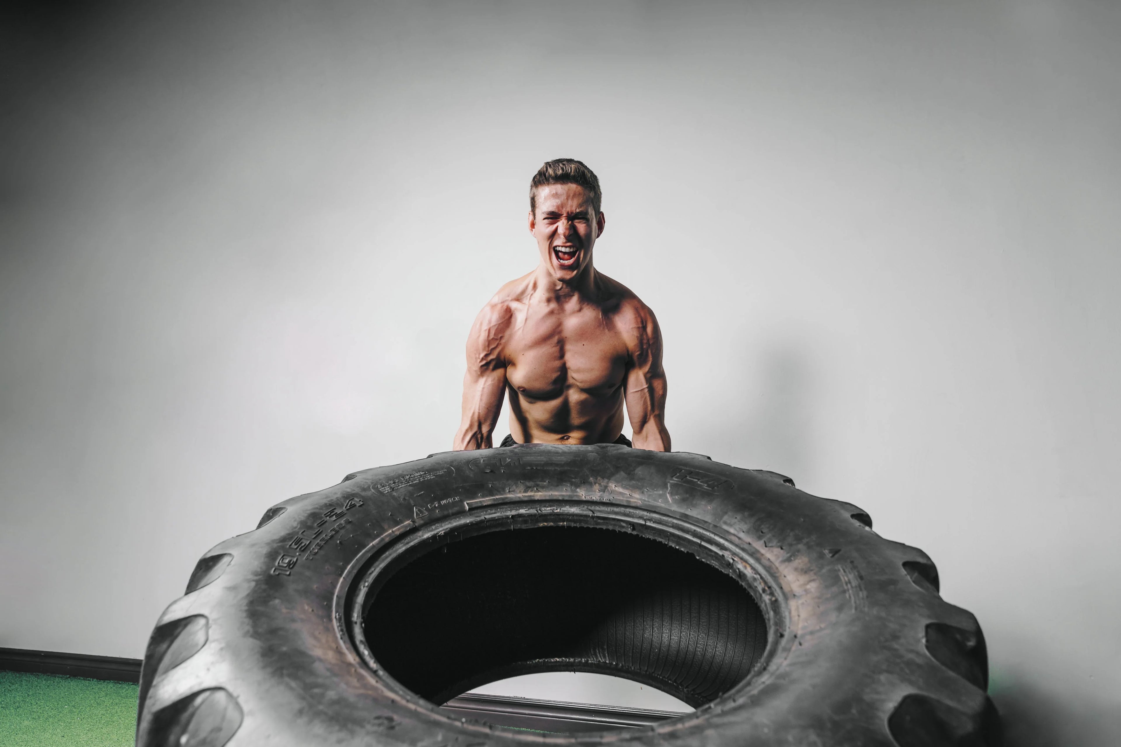 Athlete lifting a training tyre